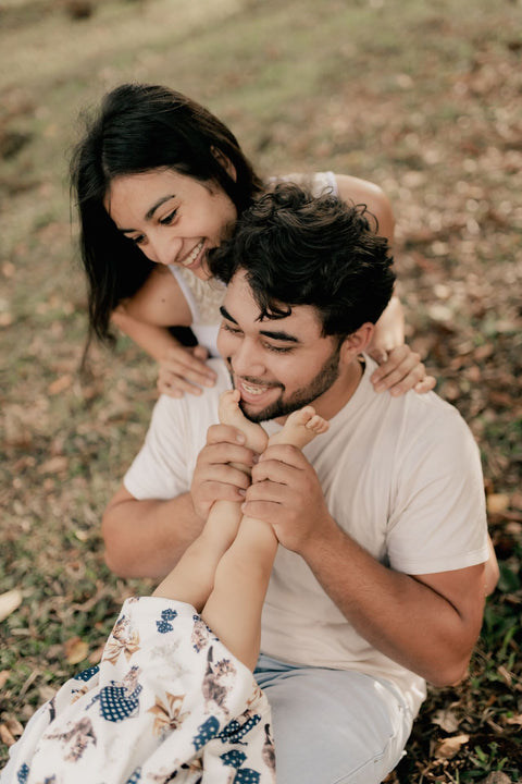 Parent playing with their child in warm natural light — the settled, present state The Grounded Parent helps you return to.